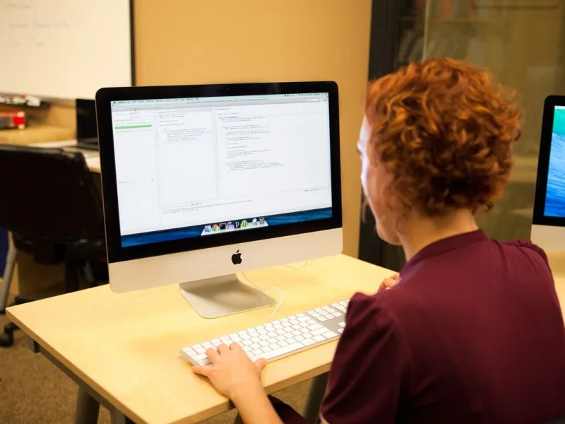 A developer writing code on a computer