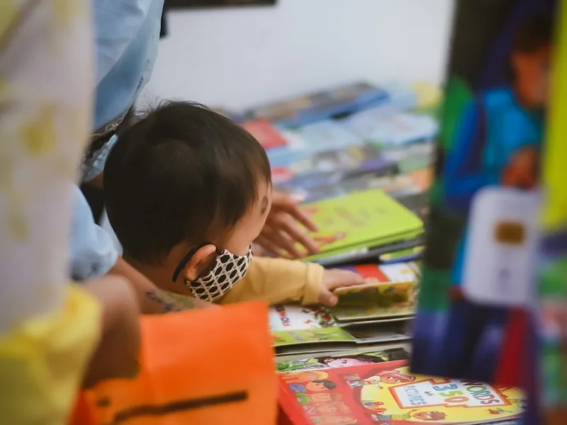 Visitors browsing books at a fair